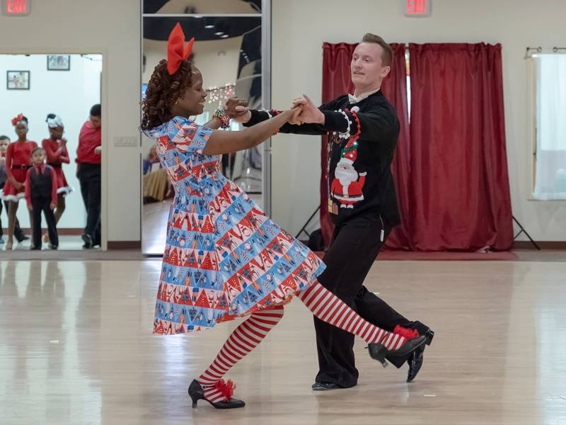 Denis dancing with student Foxtrot at Holiday Dance Showcase